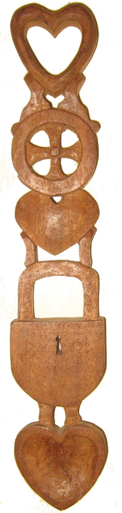 A hand-carved Welsh lovespoon with hearts and ornamental details